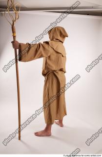 12 2019 01 JOEL ADAMSON MONK STANDING POSE WITH A…
